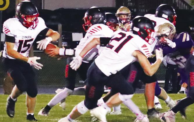 #3 Brayden Oldenkamp hands off to #15 Rory McManus while #21 Kellen Griffith blocks during the Raiders vs. Chargers game last Friday night in Onida.