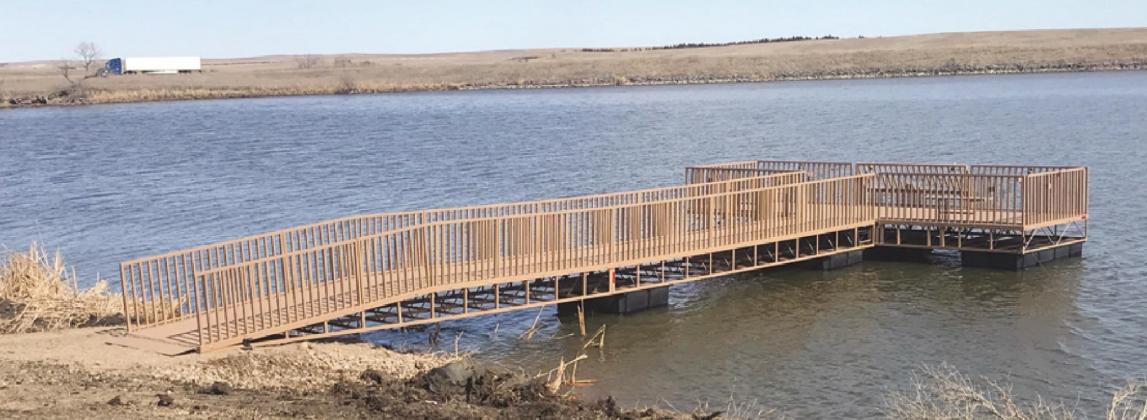 Game, Fish and Parks installs the new fishing pier dock at Brakke Dam on Monday. There is further work on the trail to the dock continuing as weather allows.