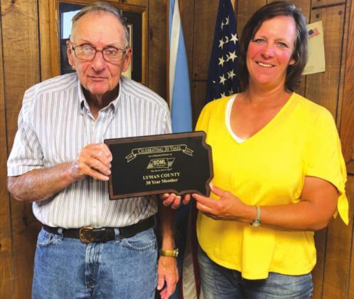 Lyman County Commissioners, Bill Lengkeek and Leslie Reuer hold the plaque honoring the county for 30 years of membership with the SDML Workers’ Compensation Fund.