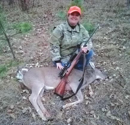 Lacey Elrod displays her white tail doe she shot in the Black Hills Nationa Forest.