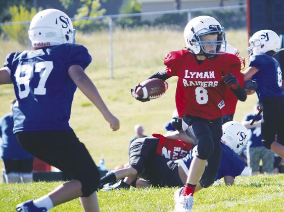 Ending homecoming week with Little Raiders Football # 8 Kane Kieffer runs the ball in for a touchdown. Both the third/fourth grade and fifth/sixth grade teams beat St. Joe’s on Saturday, September 10th. Photo by Darcy Johnson Photography