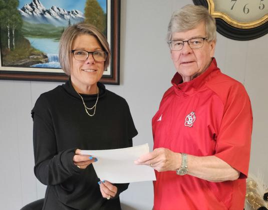 Sarah Caslin accepts a check from GLF member Herb Sundall on behalf of the Town of Kennebec for improvements to the Kennebec field for girls softball league.