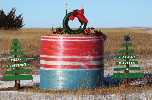 This Christmas display located at the driveway of the Owen Garnos Ranch on Hwy 248 east of Presho is made with a hay bale and a tire Christmas wreath on top with Christmas trees along side wishing everyone a Merry Christmas. PHOTO BY CONNIE PENNY/LCH