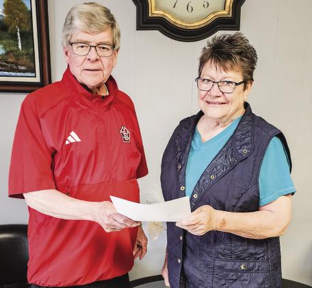 Betty Jean Mertens, Kennebec Women’s Club accepts a check from GLF member Herb Sundall.