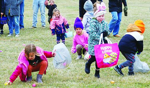 Kids race to grab the eggs, searching for the egg with a prize ticket. Right: Carson Johnson (Cade &amp; Brooklyn) fills his basket during Presho’s Easter Egg Hunt.