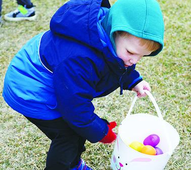 Left: William Reuman (Logan &amp; Katie) grabs an egg during Presho Chamber’s Easter Egg Hunt on Saturday.